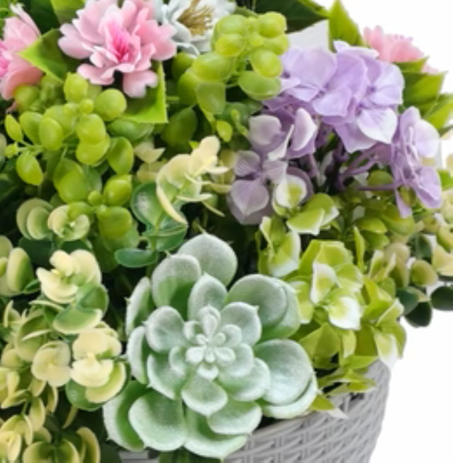Realistic cascading succulent arrangement in grey woven pot