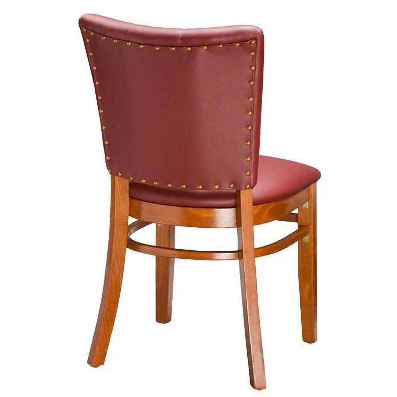 Rear view of the Drake upholstered beech wood dining chair showing decorative nail trim on the backrest. Solid walnut finish frame with cream upholstery. Custom finishes and fabric options available.