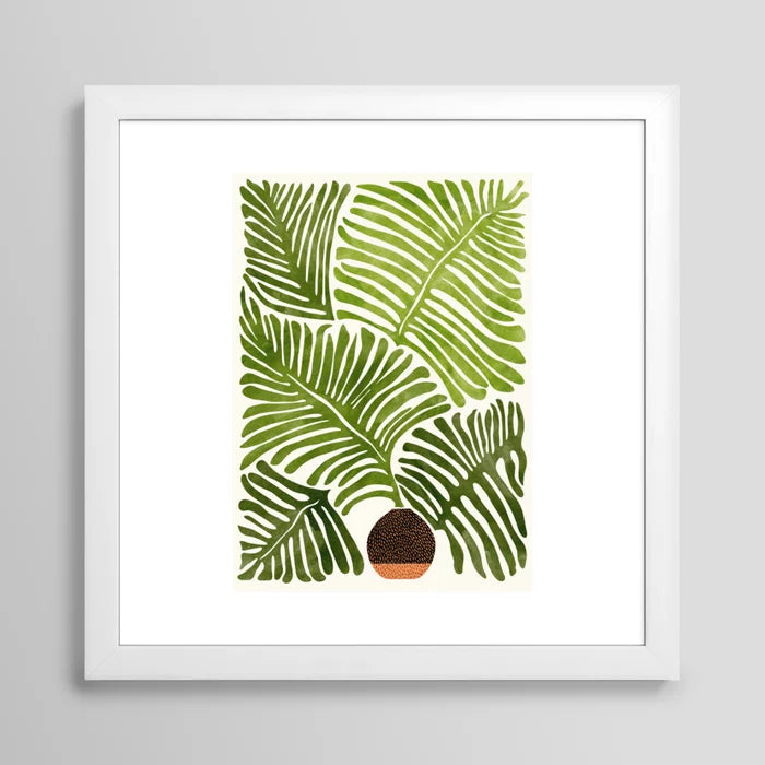 Summer Fern watercolor art print in white frame displayed in café setting