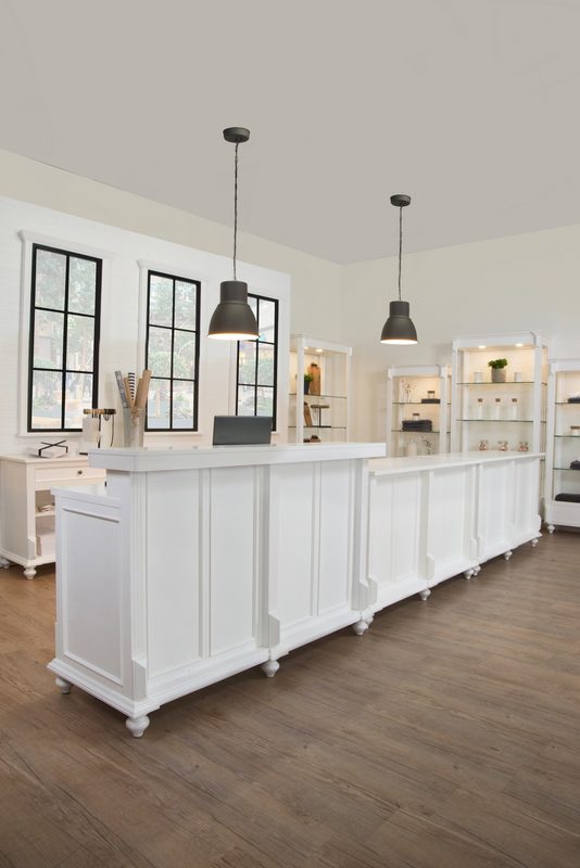Front display view of the Vintage Flat Top Retail Counter in a white painted finish, showing the clean flat countertop surface and organized shelving below used for retail checkout and merchandise presentation.