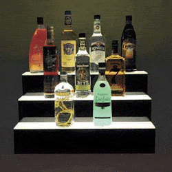 Three-tier LED-lit acrylic back bar bottle riser with black base and glowing translucent step tops