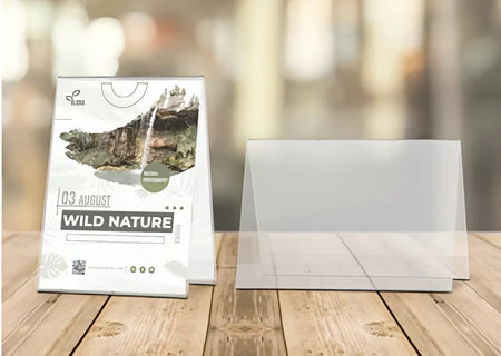 Clear acrylic tent card holder shown on tabletop, angled for double-sided display