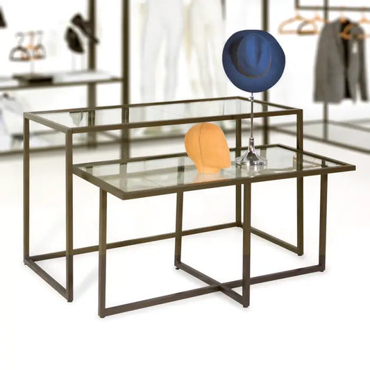 Front view of the Contempo Nesting Display Table featuring a statuary bronze steel frame and clear glass top, designed for upscale multi-level retail merchandising.
