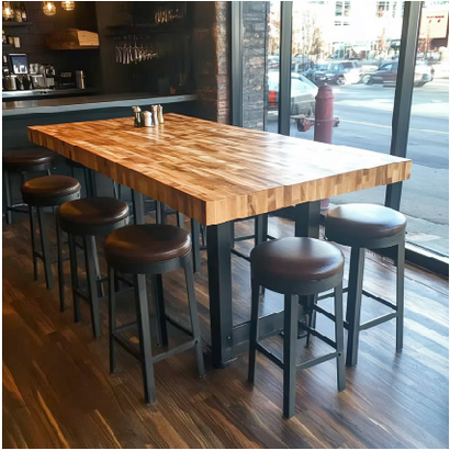 Restaurant dining setup featuring butcher block tables with chairs.