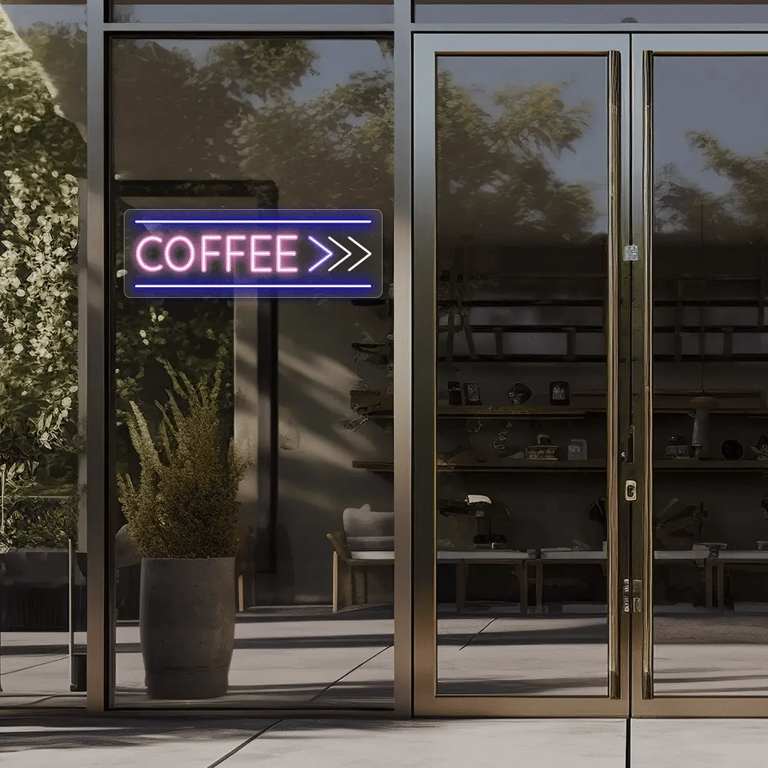 Neon coffee sign outside a building with glass doors.