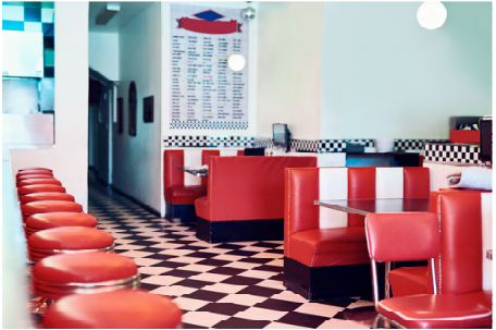 Diner interior with red booths and checkered floor
