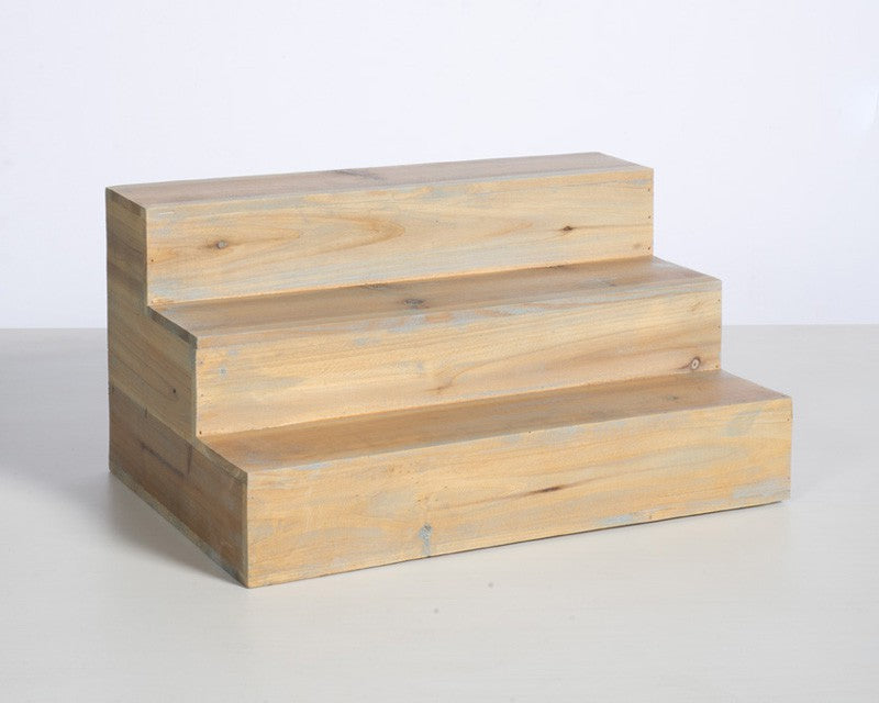 Three-step distressed pine back bar bottle riser with compact wooden frame and rear storage compartment.