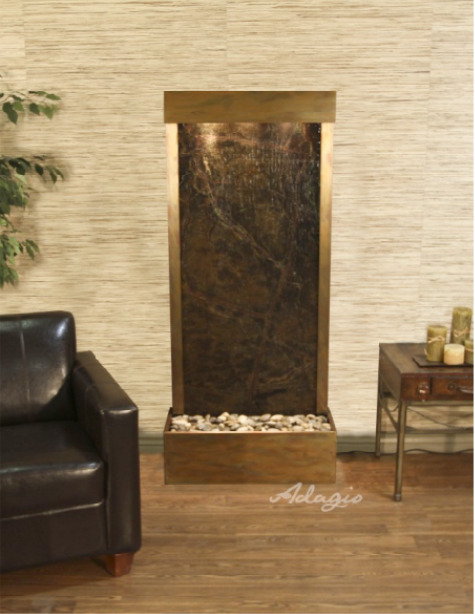 Fountain with water feature in a room setting, featuring a leather chair and decorative items.