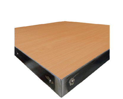 Close-up view of steel edge banding on high-pressure laminate restaurant table top, showing exposed fasteners and industrial metal trim