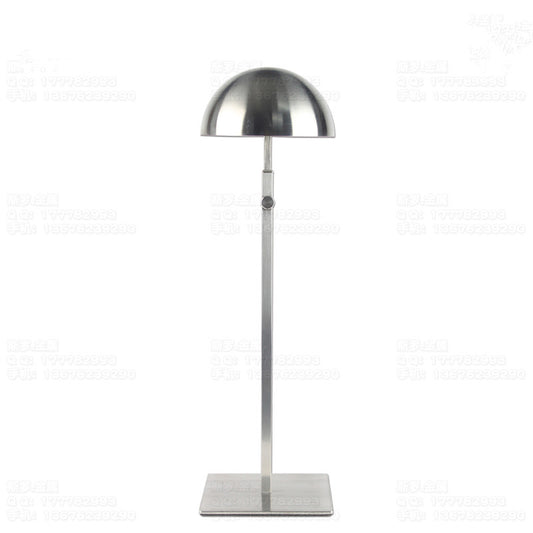 Adjustable brushed steel hat display stand with round base and vertical post.