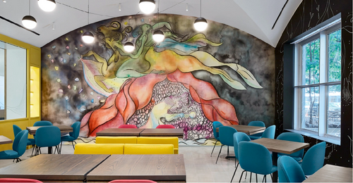 Modern interior with colorful mural on the wall, tables, and chairs.