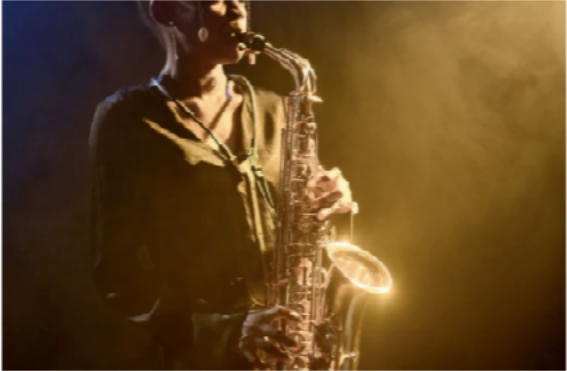 Person playing a saxophone with a warm glow and smoke effect