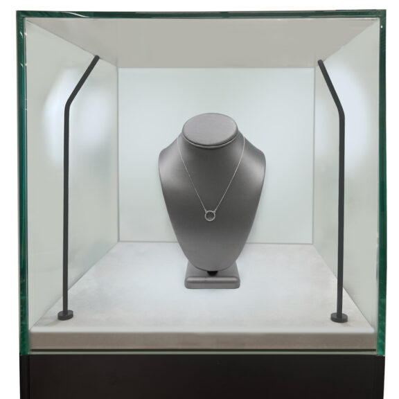 Close-up zoom of the black pedestal display case showing the 3/8-inch thick locking glass showcase and smooth melamine pedestal surface.