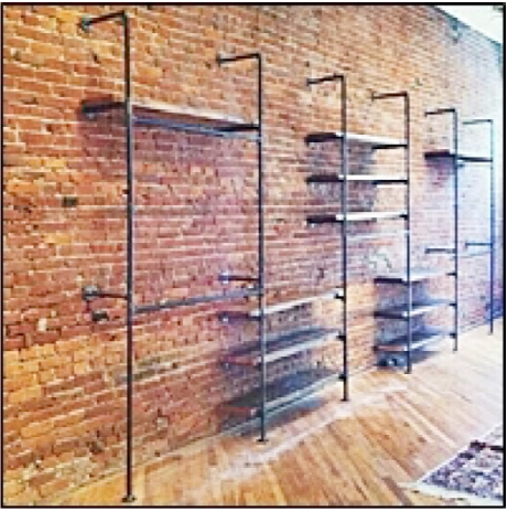 Metal shelving units against a brick wall in an indoor setting