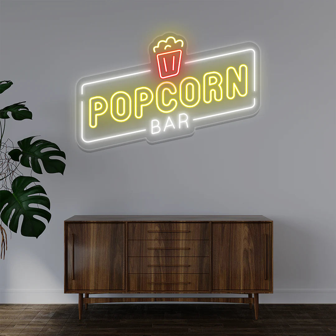 Popcorn Bar LED Neon Sign in warm white light adding vintage movie-theater ambiance to entertainment room or bar wall.
