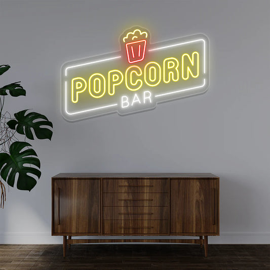 Popcorn Bar LED Neon Sign in warm white light adding vintage movie-theater ambiance to entertainment room or bar wall.