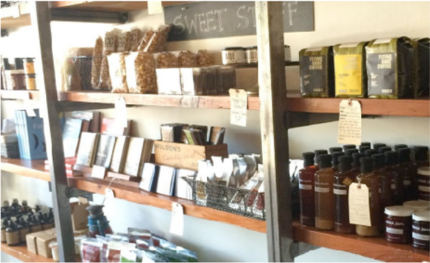 Shelves with various products including jars and boxes in a store setting.