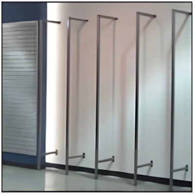 Raw steel retail outrigger showing exposed metal tubing and universal double-slotted uprights used for supporting shelves, hangrails, and merchandise displays.
