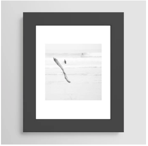 Framed black and white abstract art print on a gray wall