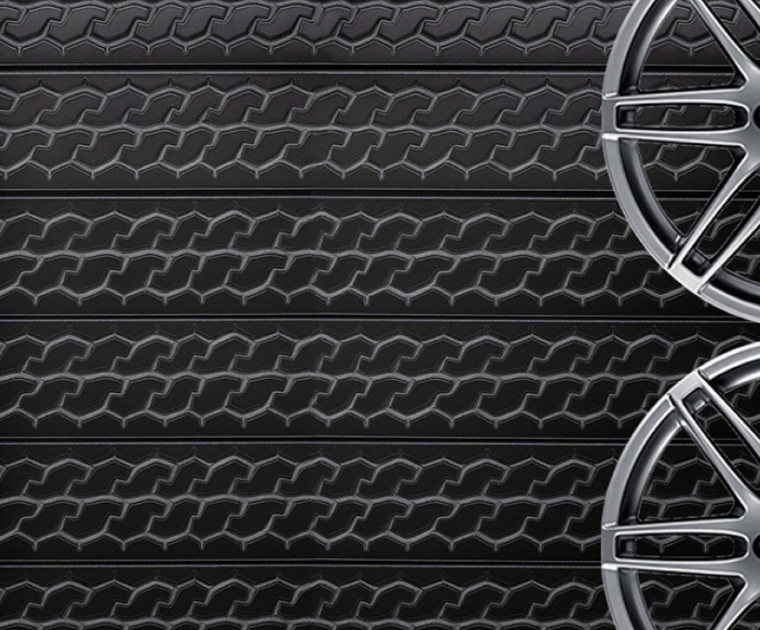interior installation featuring a 24 by 96 inch tire tread wall panel used for automotive-themed décor.