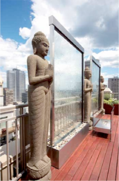 Buddha statue on a rooftop with cityscape in the background