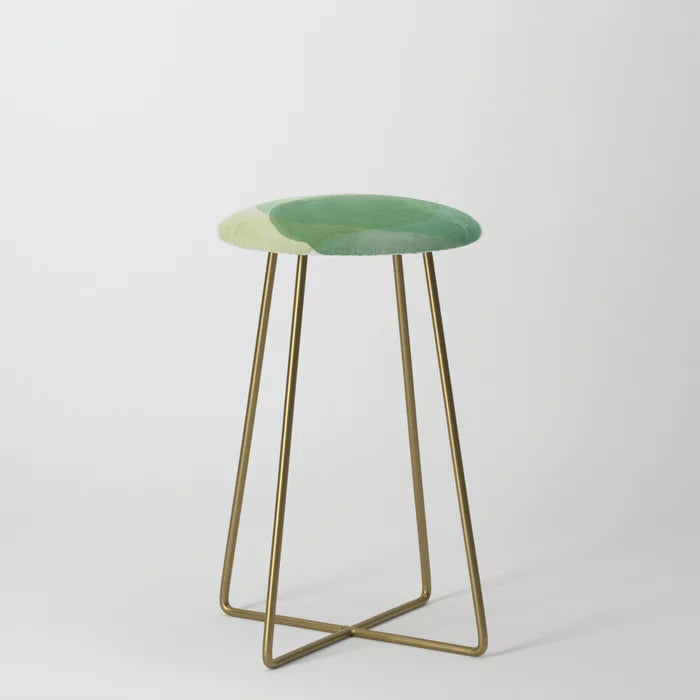 Abstract Organic Watercolor Shapes in Green Counter Stool by Apricot-Birch with gold steel legs – modern vegan leather seating for hotel dining areas, cafés, and restaurant bars
