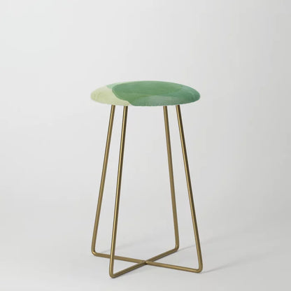 Abstract Organic Watercolor Shapes in Green Counter Stool by Apricot-Birch with gold steel legs – modern vegan leather seating for hotel dining areas, cafés, and restaurant bars