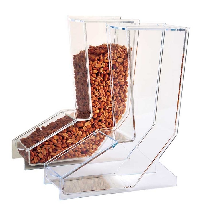 Front view of a clear acrylic bulk candy and nut dispenser showing the top refill lid, front access door, and included scoop.