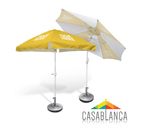 Two yellow and white patio umbrellas with Casablanca logo on a white background