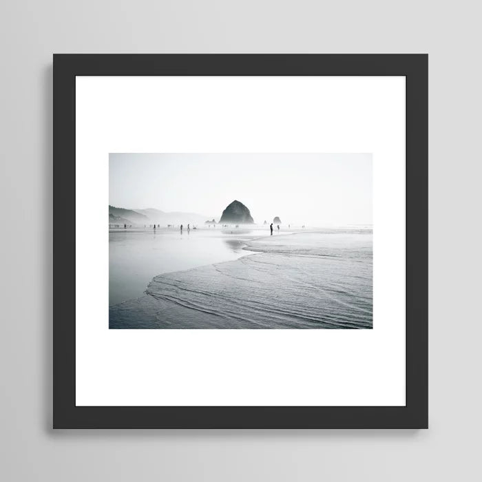 Cannon Beach Art Print by Hannah Kemp in black frame featuring serene coastal scenery and ocean tones, perfect wall art for boutique hotels, beach cafés, and modern restaurant interiors.