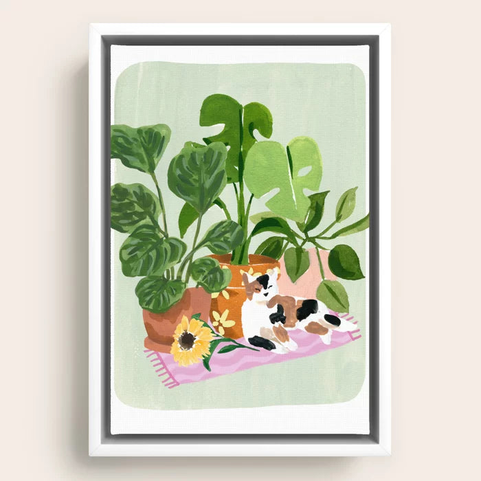 Minimal botanical and cat artwork framed in white for a clean modern wall display