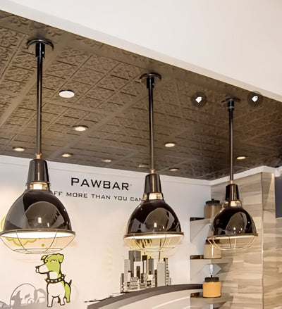 Pendant lights hanging in a modern interior setting with 'PAWBAR' branding.