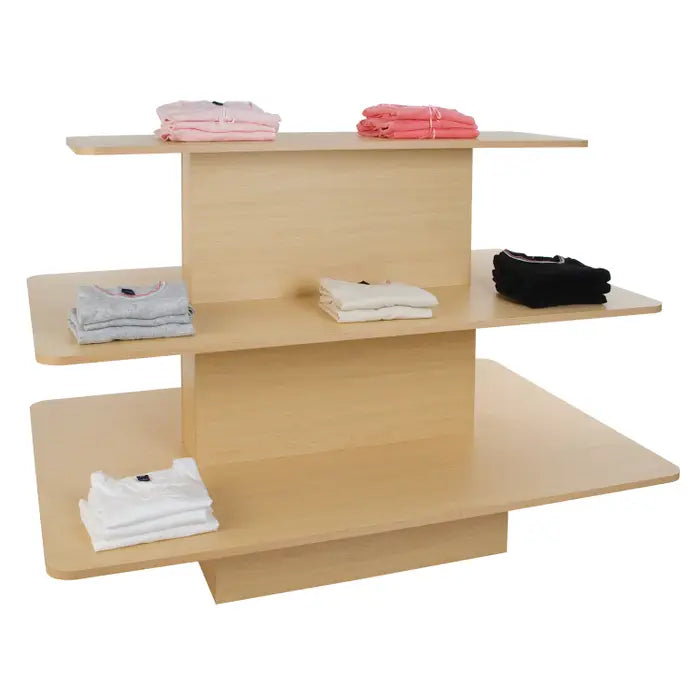Maple 3-tier rectangular display table with merchandise displayed on the shelves, demonstrating product organization and visibility in a retail environment.