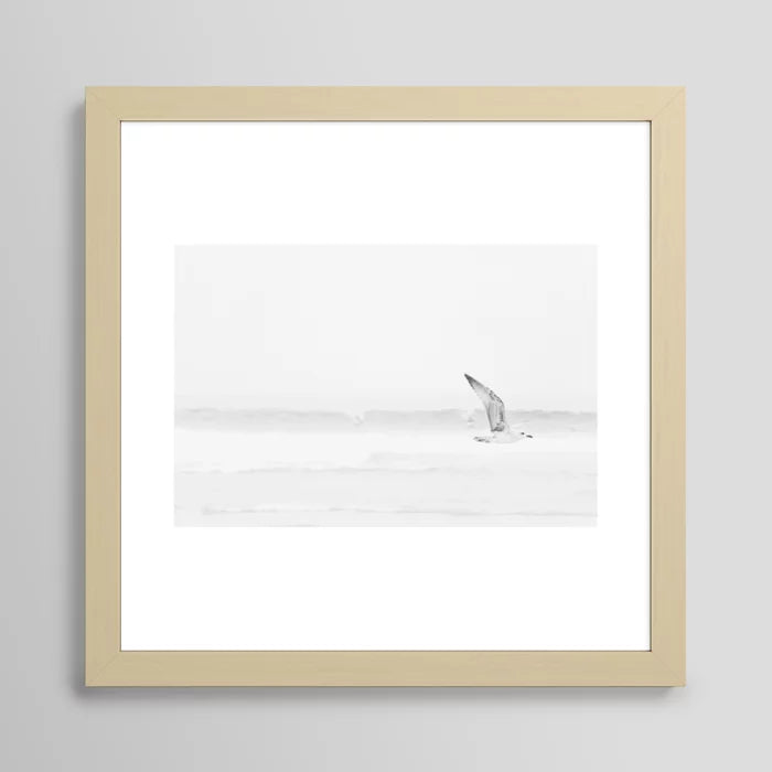 Minimalist seagull beach print framed in light maple wood – black and white ocean photography wall decor