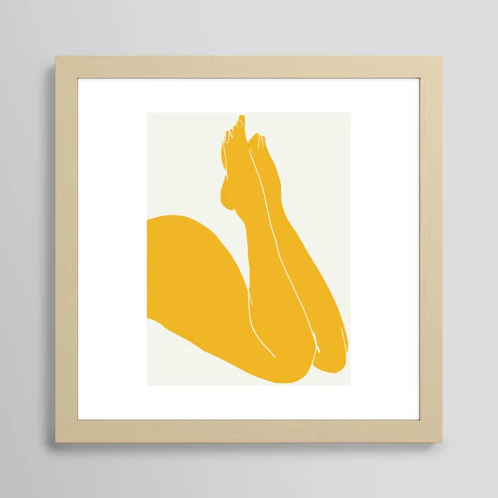 Nude in Yellow 3 art print in maple frame styled in a coffee shop interior
