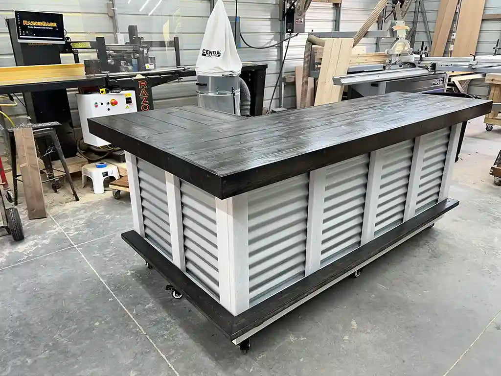 L-shaped wood and metal portable bar with corrugated metal front and dark wood finish