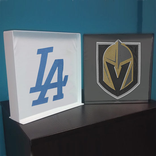 Two metal t-shirt display boxes shown in raw steel and black finishes