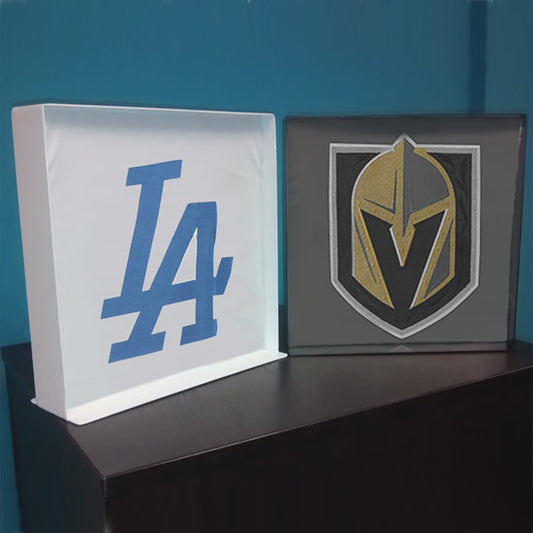 Two metal t-shirt display boxes shown in raw steel and black finishes