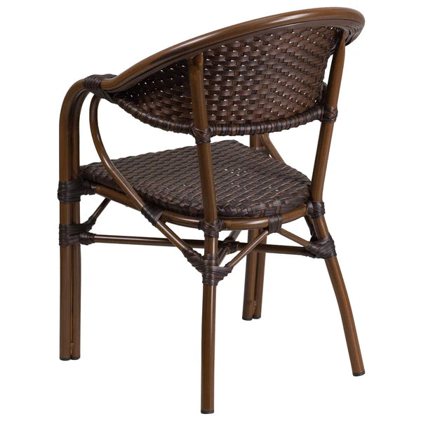 Back angle view of dark brown rattan café chair with curved back, integrated arms, and sturdy cross-braced frame.