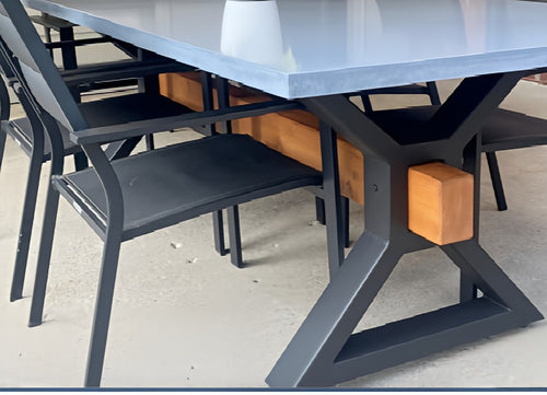 Table with metal legs and wooden blocks on a concrete floor
