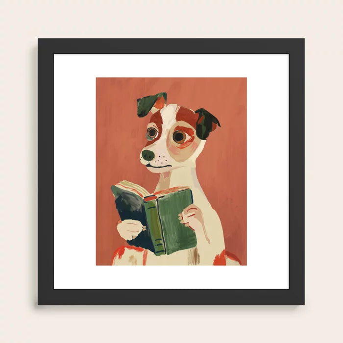 black wood framed artwork of a dog reading a book on a red background