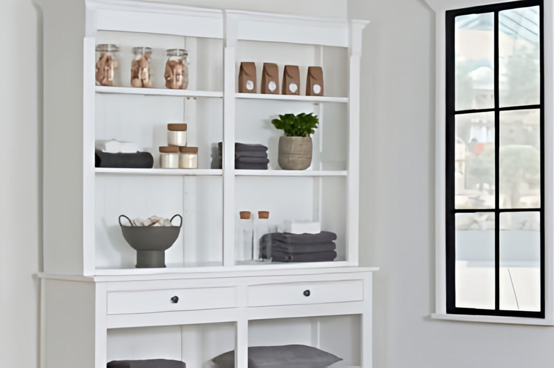 White storage cabinet with shelves and drawers in a room with a window.