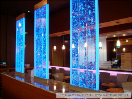 Blue LED water wall feature in a modern indoor setting