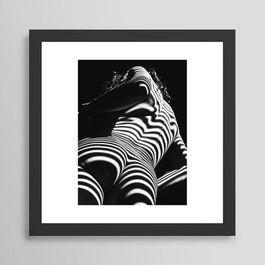Woman zebra striped nude art print in black frame, contemporary décor for upscale restaurants and boutique hotels